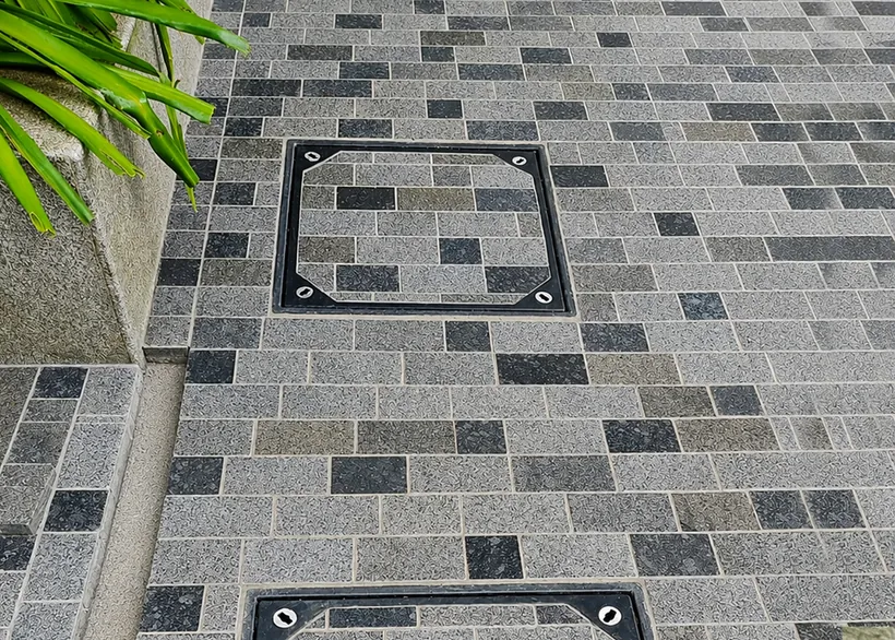 Recess cover filled with pavers, blending into path